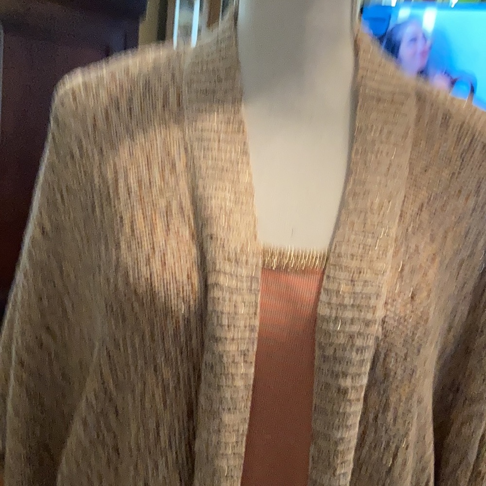 Sweater. Tank top has gold around the neck